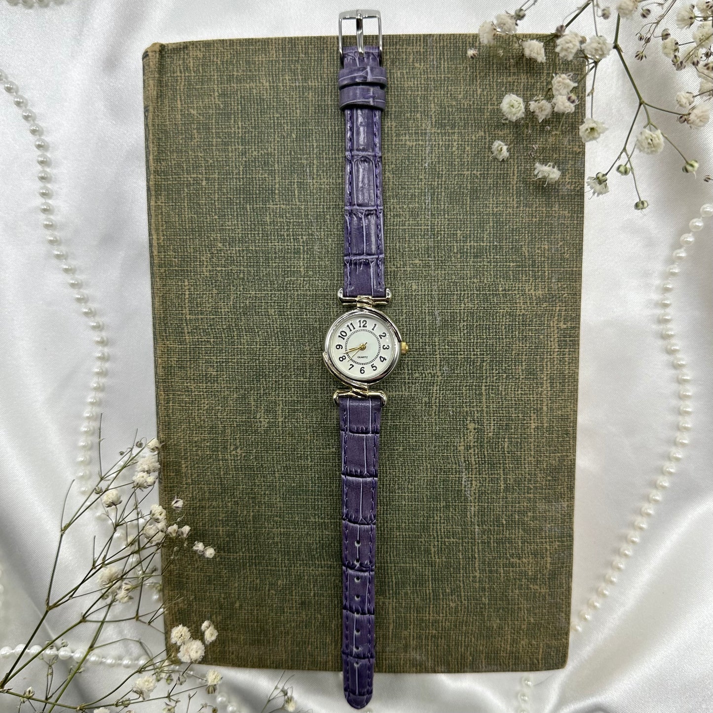 Vintage silver and gold tone watch with purple band and quartz movement