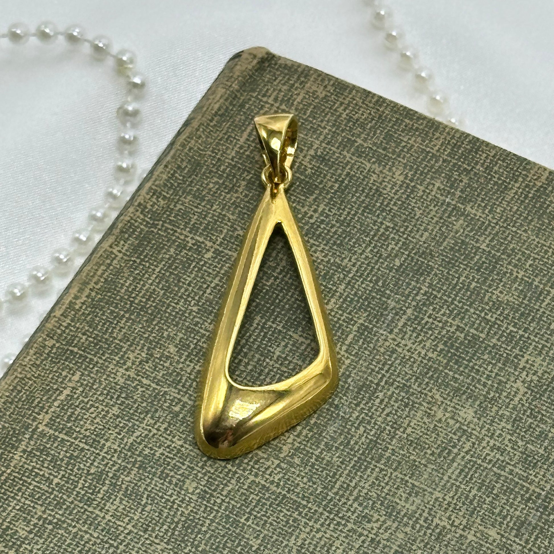 Vintage gold tone charm pendant.
