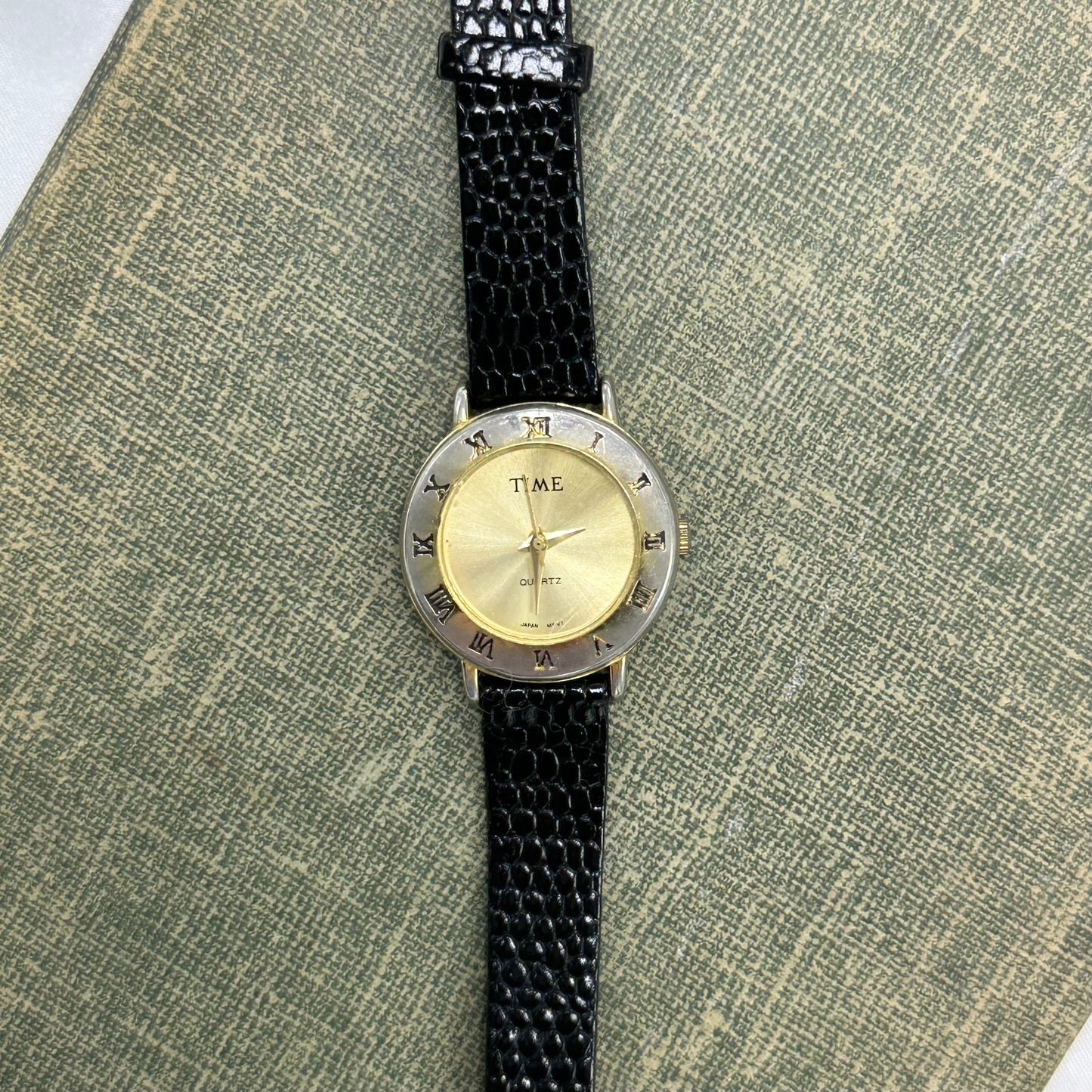 Gold Round Dial Watch with Roman Numeral Markers