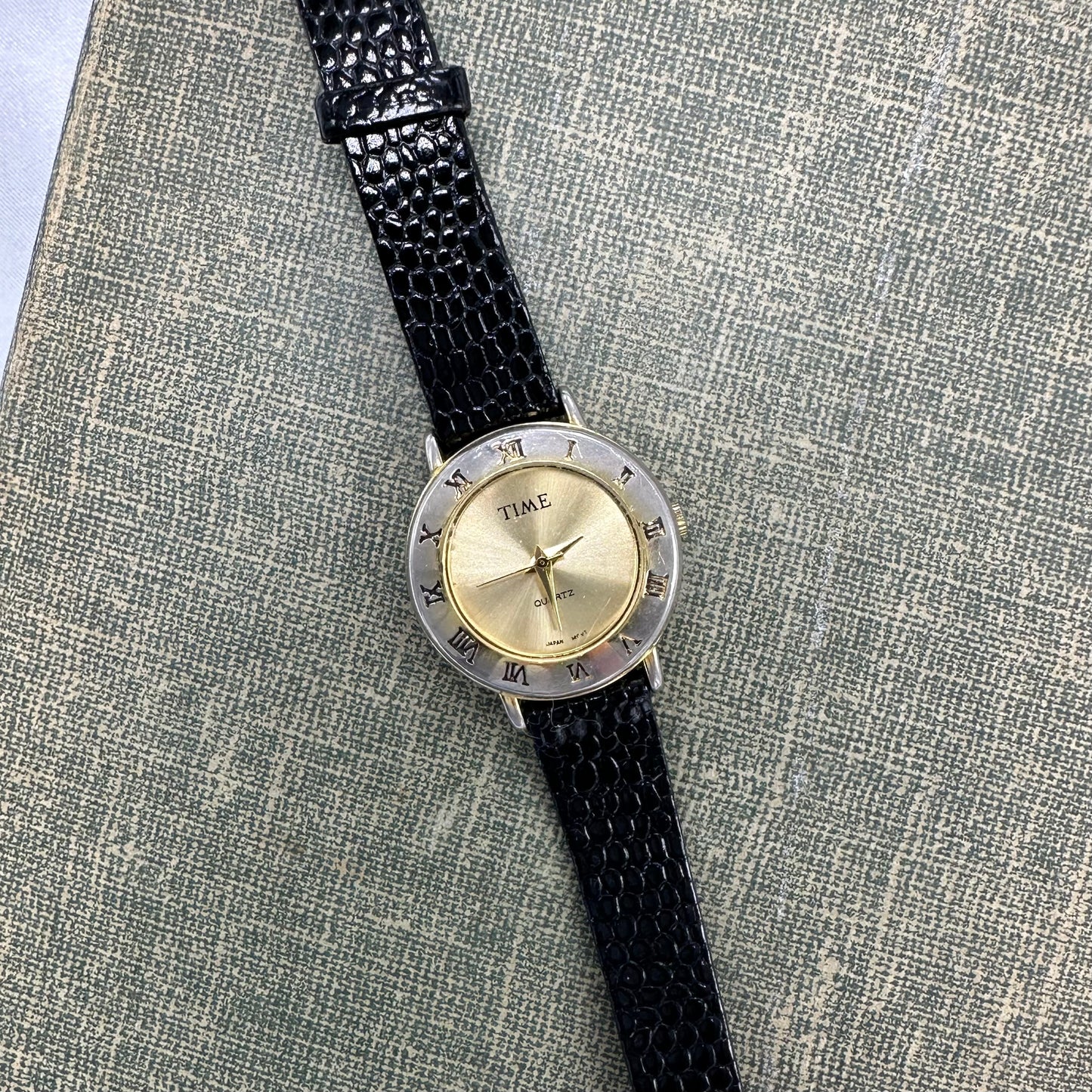 Gold Round Dial Watch with Roman Numeral Markers