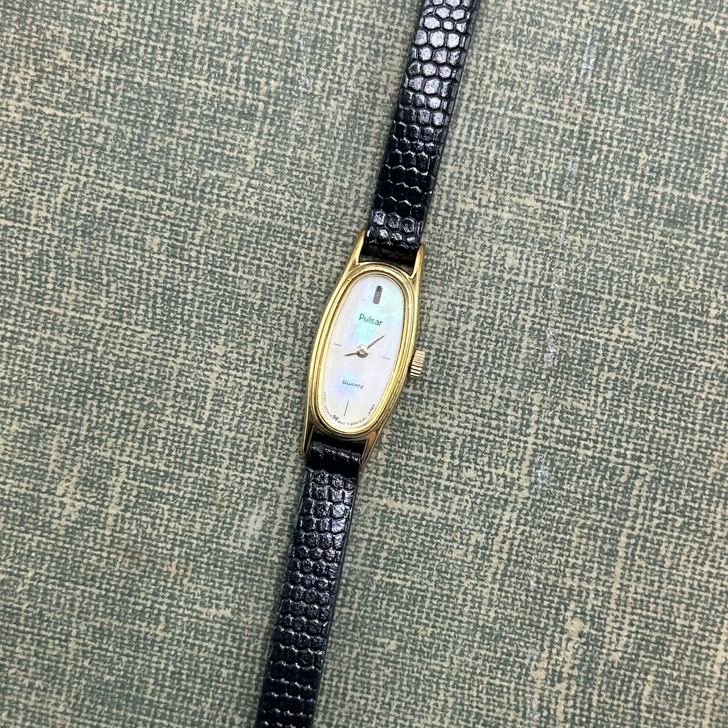 Dainty vintage Pulsar watch with mother of pearl dial and gold tone case. Band is genuine leather made in France.