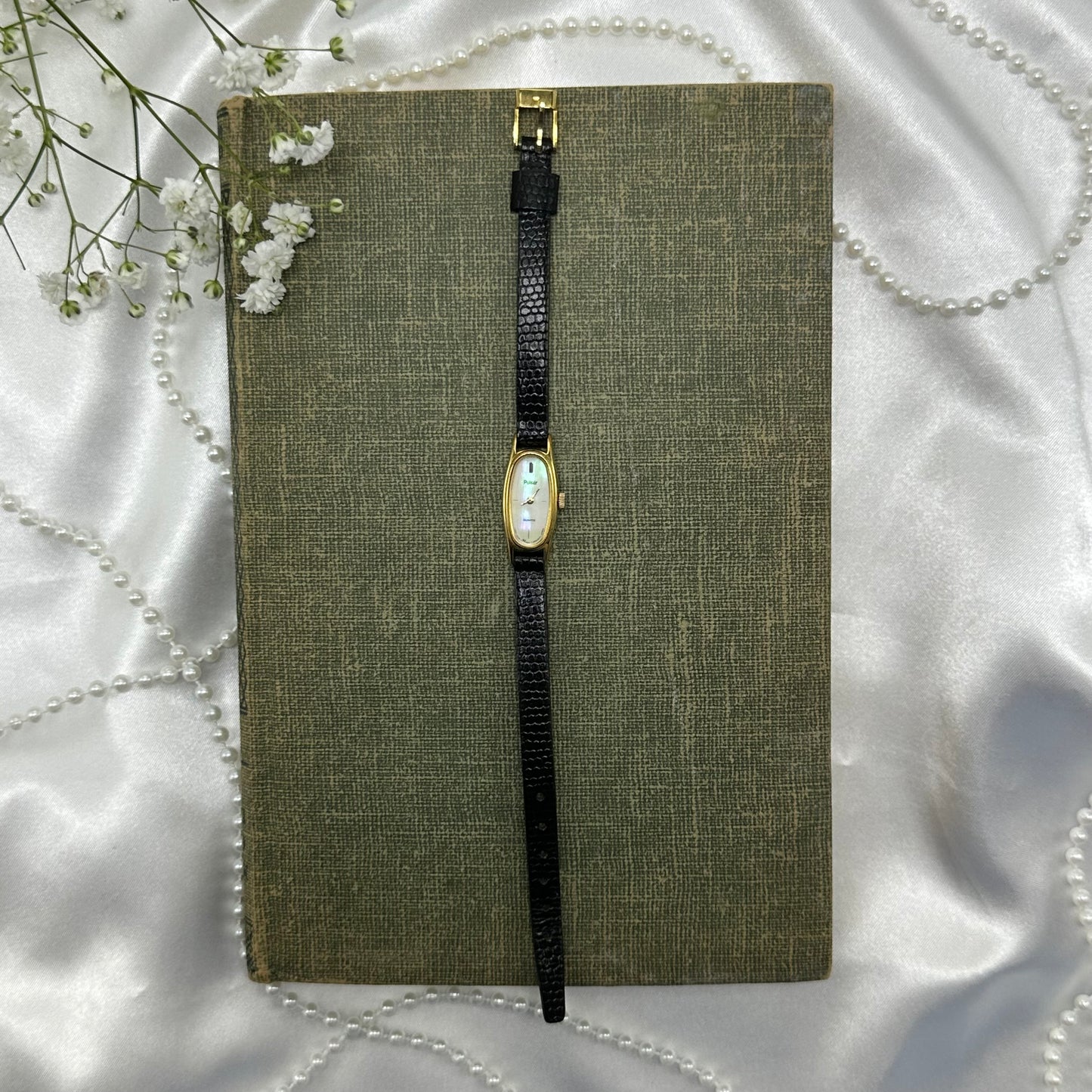 Dainty vintage Pulsar watch with mother of pearl dial and gold tone case