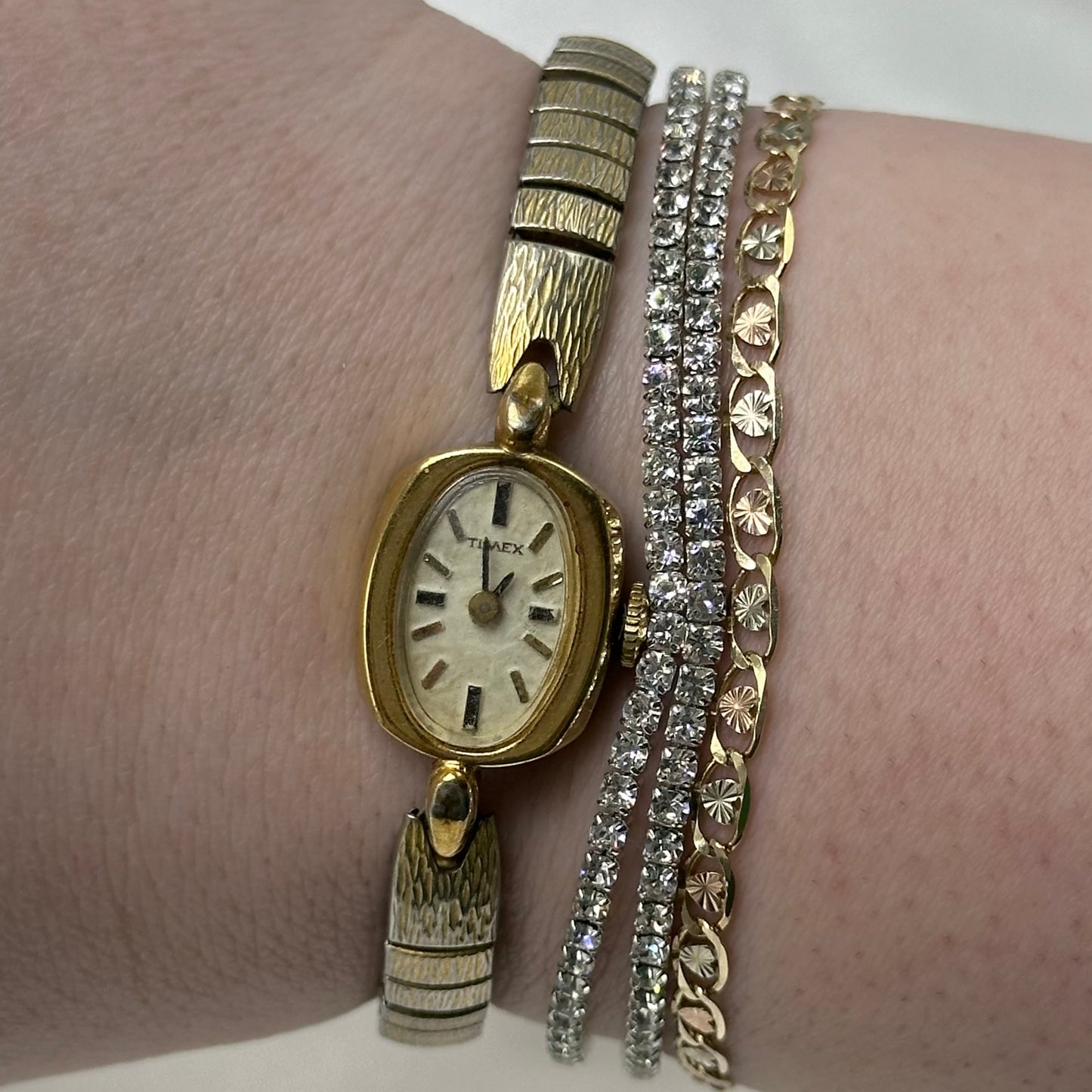 Gold tone Timex manual winding watch with oval dial