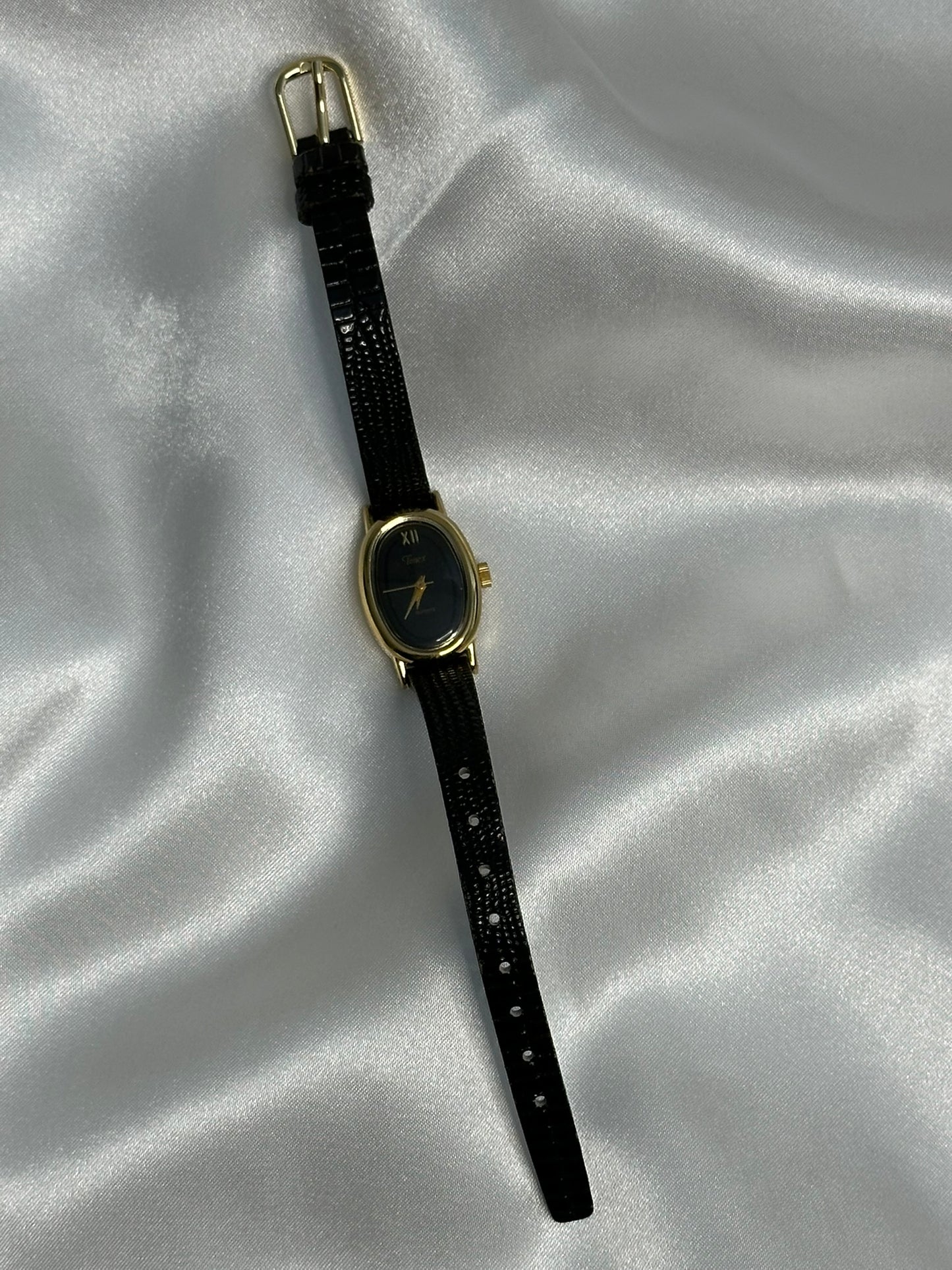 Gold tone and black Timex with quartz movement and genuine black leather band