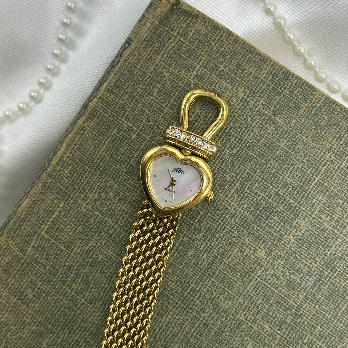 Gold tone mother of pearl heart dial Alto