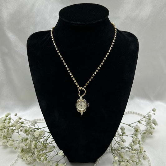 Gold tone rhinestone necklace with heart bail and vintage watch pendant. Watch does not run.
