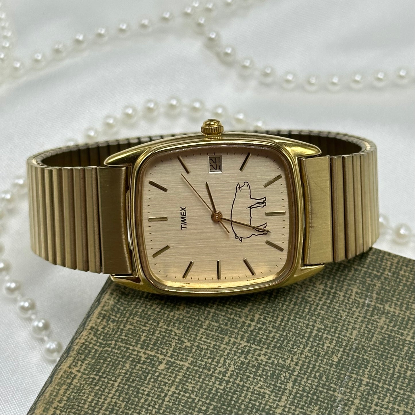 Rare vintage gold tone custom Timex with a pig on the dial. Watch has date display and quartz movement.