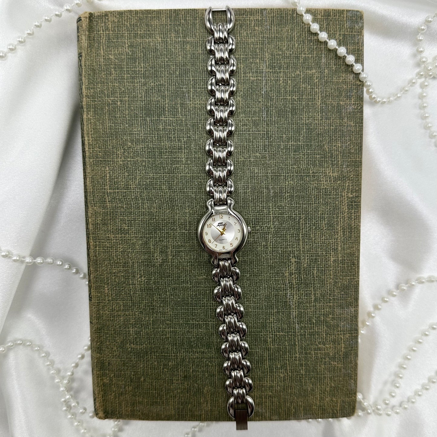 Silver tone Fabergé round dial watch with quartz movement