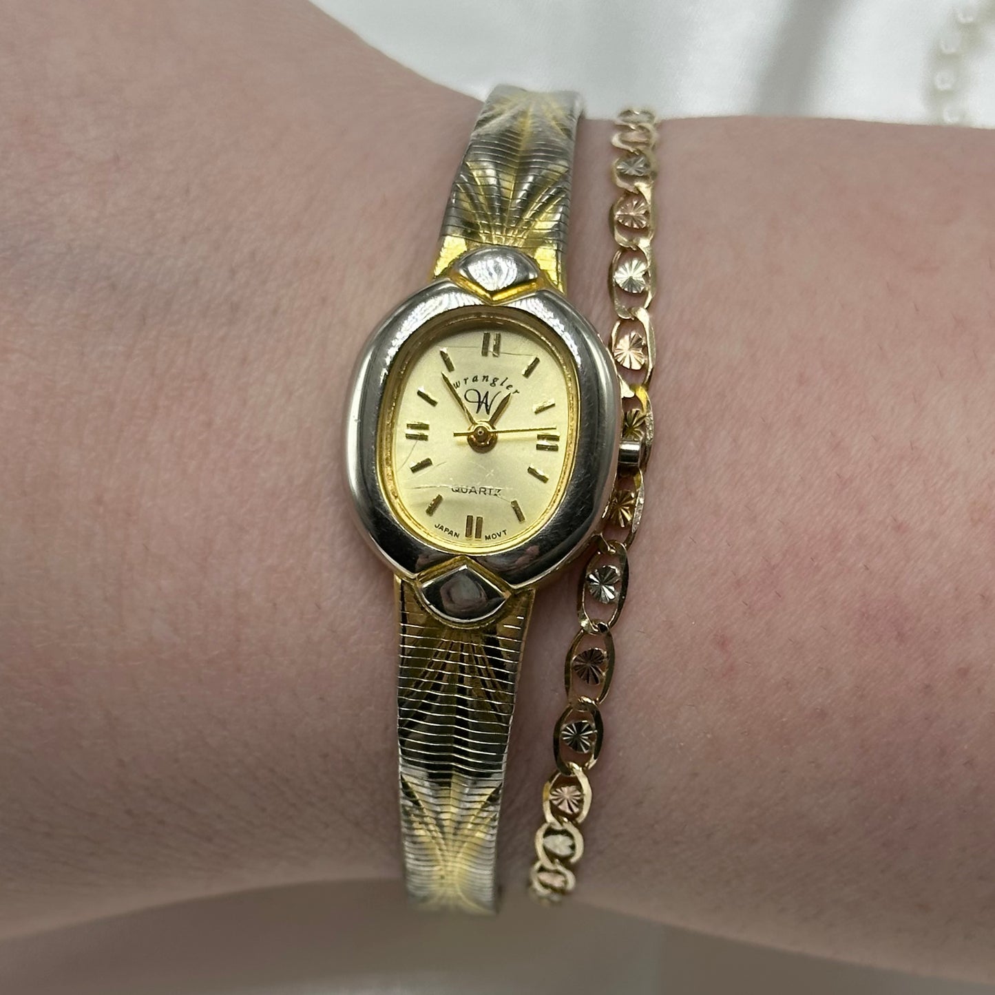 Two-tone Wrangler oval dial watch with quartz movement and clasp band