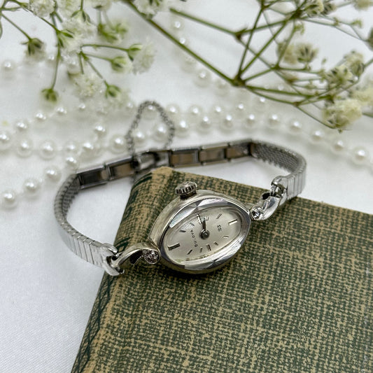 Vintage 10k rolled gold plated Bulova manual winding watch with clasp band and safety chain. Watch comes with original B crown