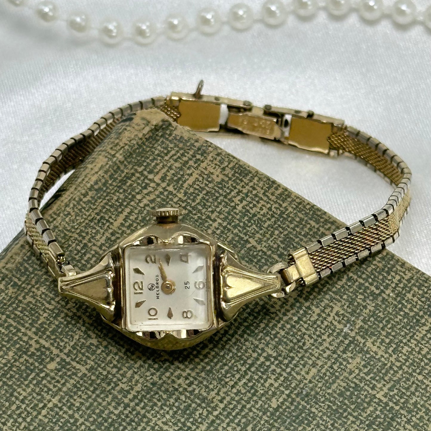 Vintage 10k rolled gold plated manual winding Helbros 25 jewels watch with elegant 10k gold filled clasp band.