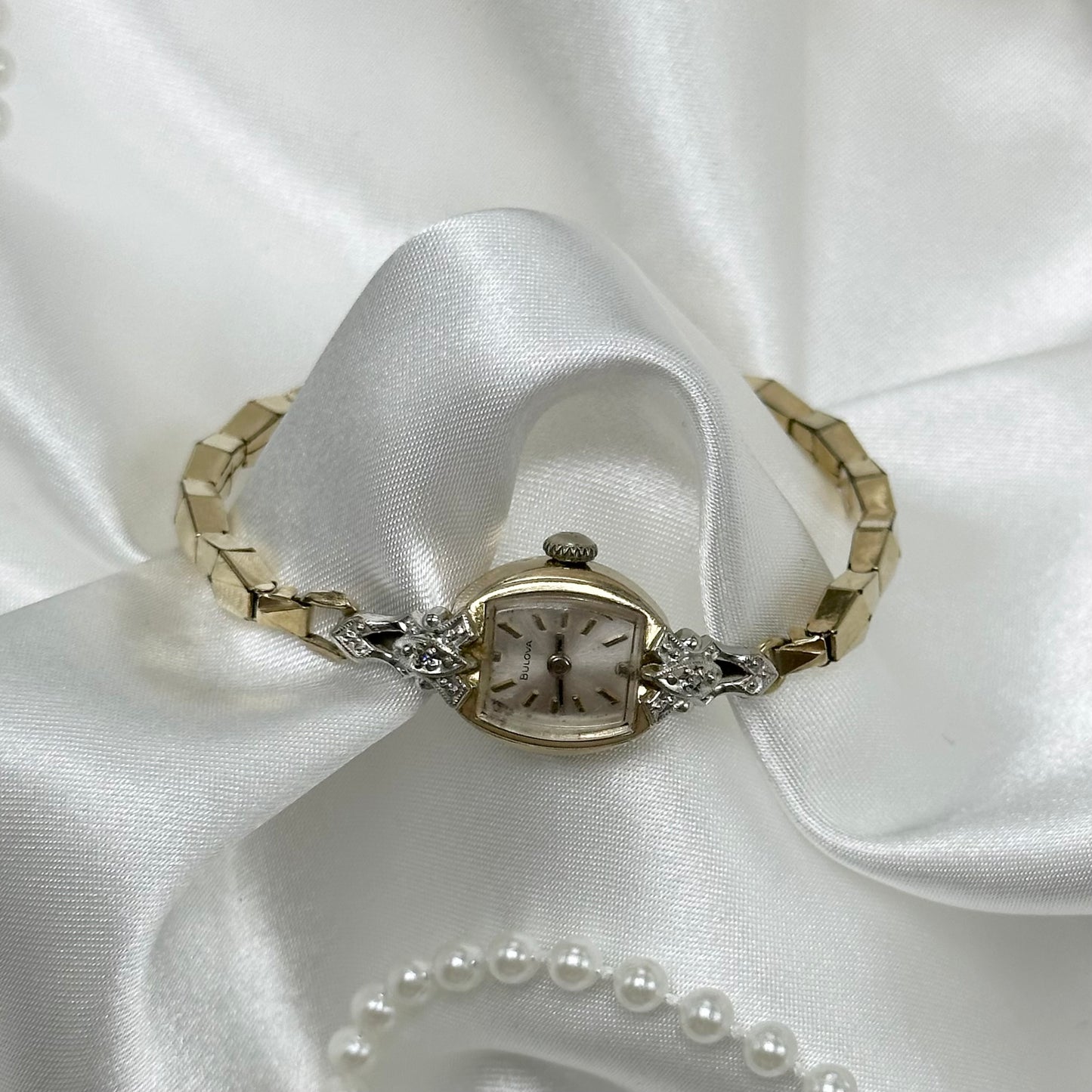 Vintage Diamanté Bulova 10k rolled gold-plated manual winding watch with stretchable band from 1971. Watch comes with original B crown