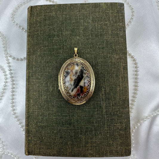 Vintage filigree oval hanging photo locket with gorgeous multicolor stone.