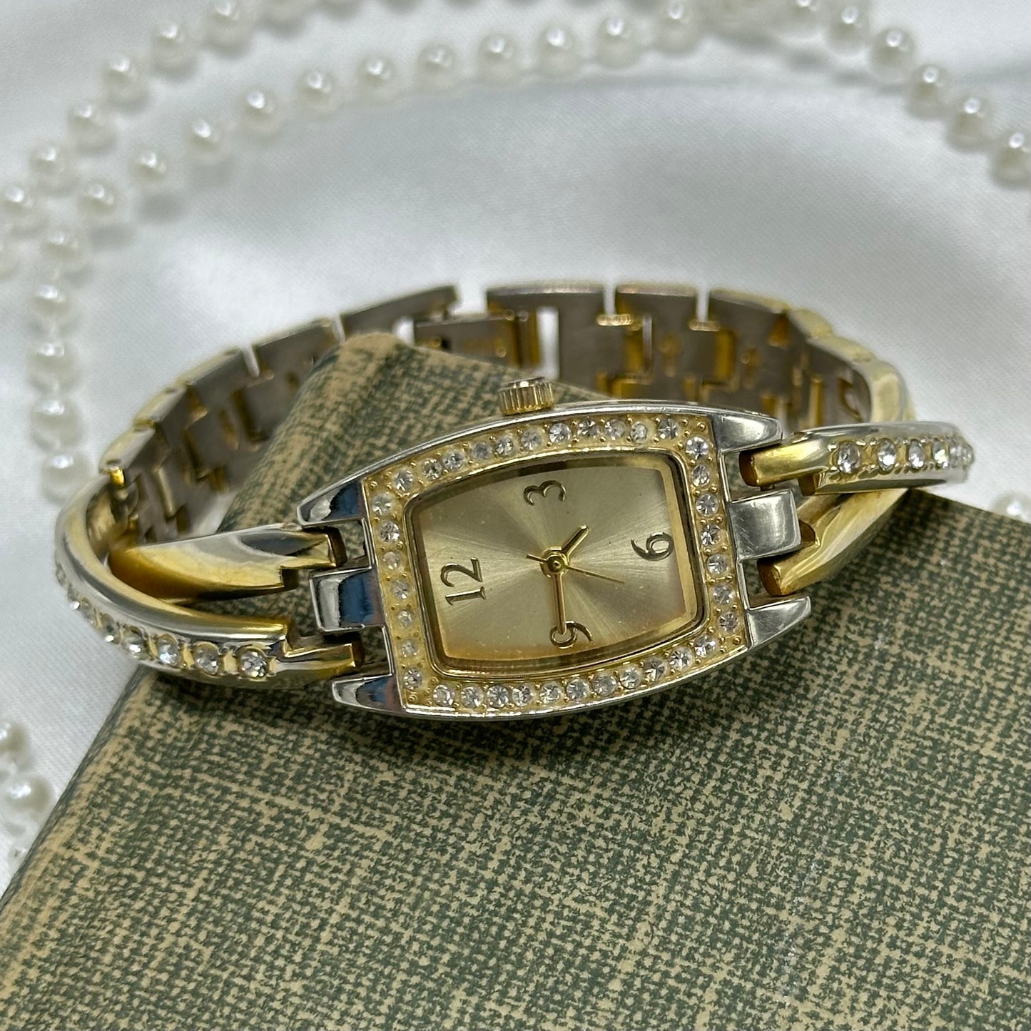 Vintage gold and silver tone diamanté watch with rectangle dial and crossed cuff style band.