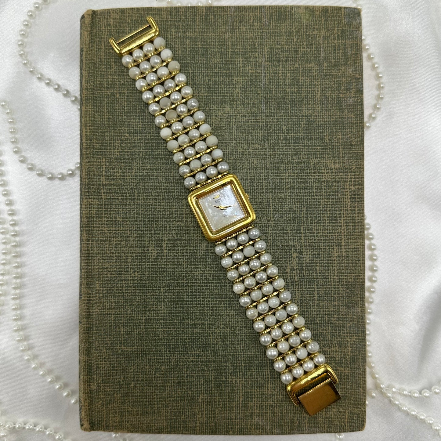 Vintage gold tone Anne Klein watch with pearl bead band and mother of pearl dial.