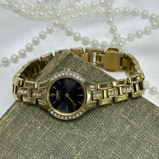 Vintage gold tone Citizen EcoDrive watch with diamanté round black dial and diamanté band.