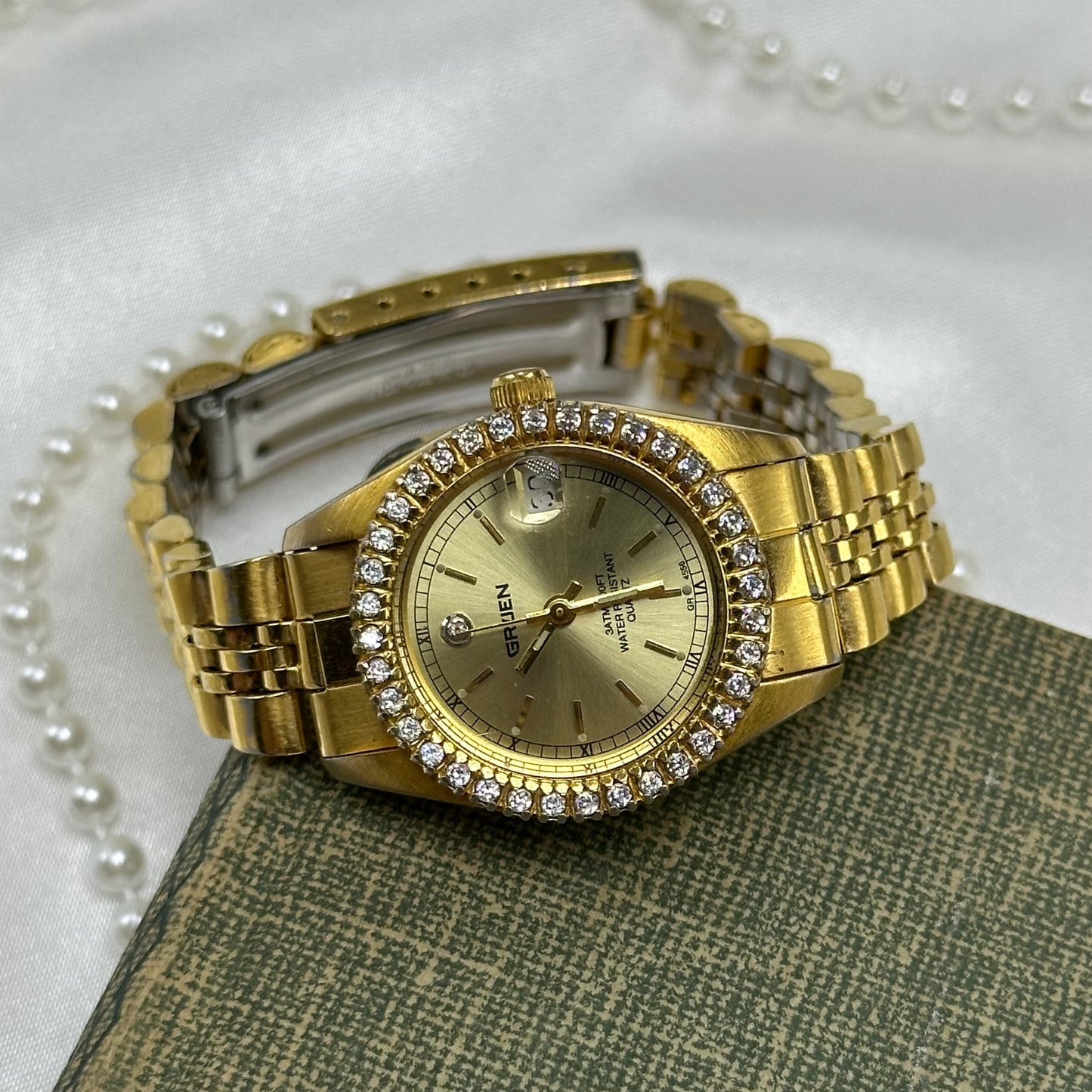 Vintage gold tone Gruen watch with diamante gemstones and date display