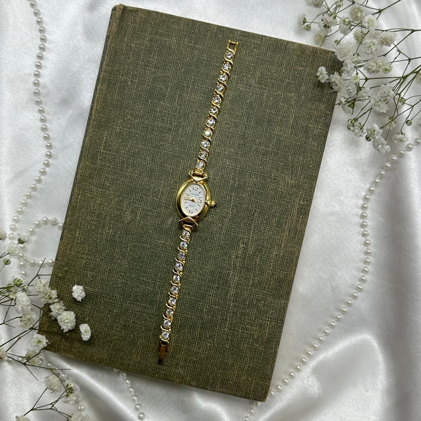 Vintage gold tone diamanté Gloria Vanderbilt watch with clasp band