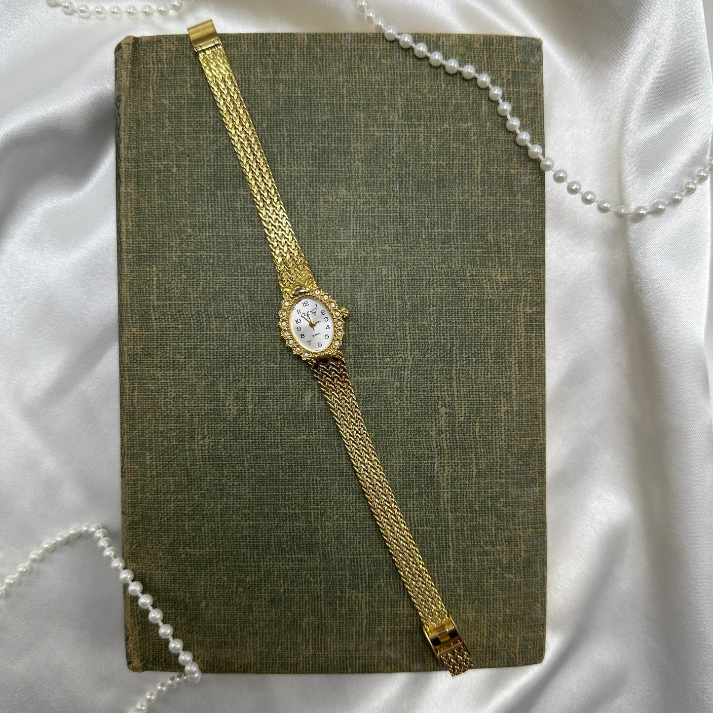 Vintage gold tone diamanté watch with quartz movement and clasp band