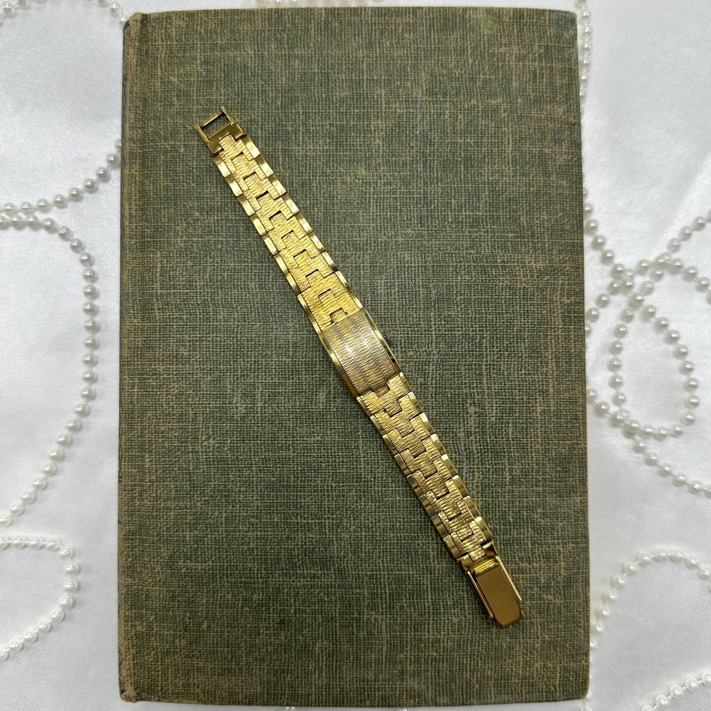 Vintage gold tone manual winding La Marque watch with peek a boo dial.
