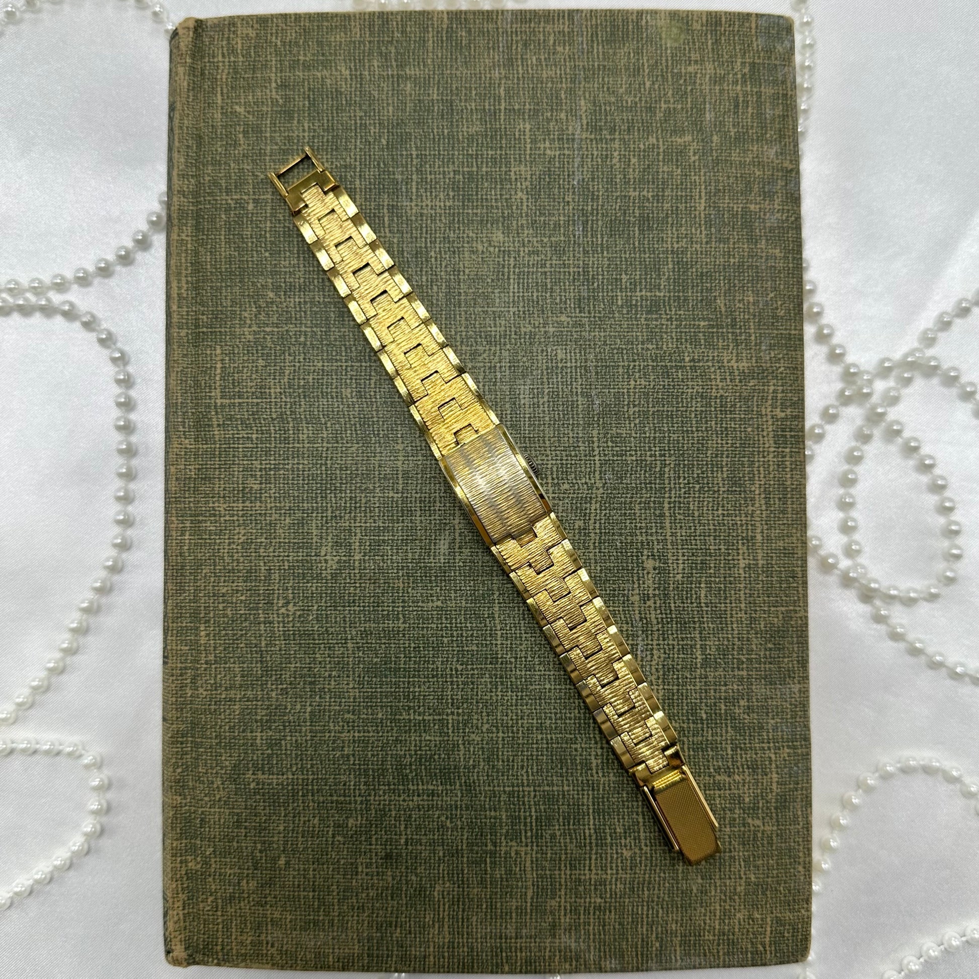 Vintage gold tone manual winding La Marque watch with peek a boo dial.