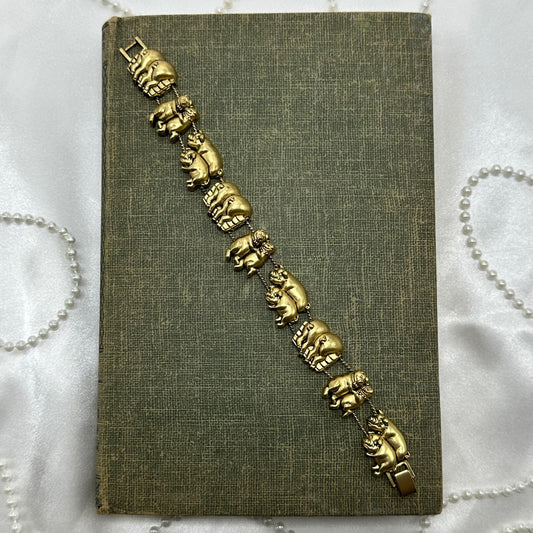 Vintage gold tone pig charm bracelet.
