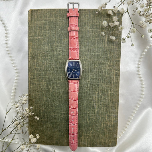 Vintage pink and silver tone Avenue watch with navy blue dial and quartz movement.