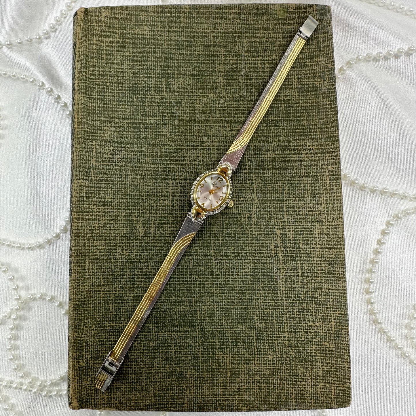 Vintage silver and gold tone Belisimo heart watch with detailed two-tone band and bubble dial.