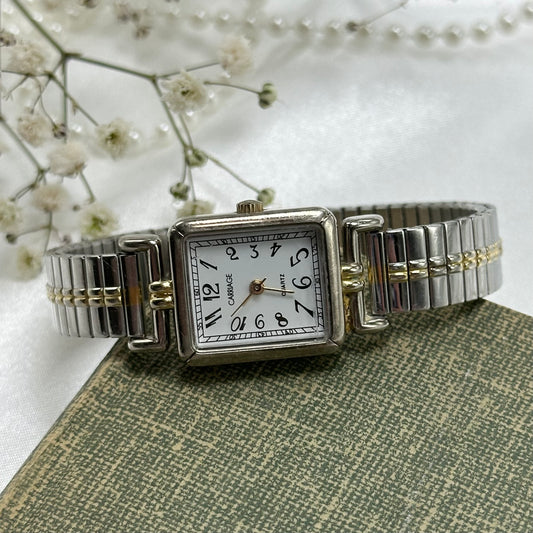 Vintage silver and gold tone Carriage watch with quartz movement and stretchable band.