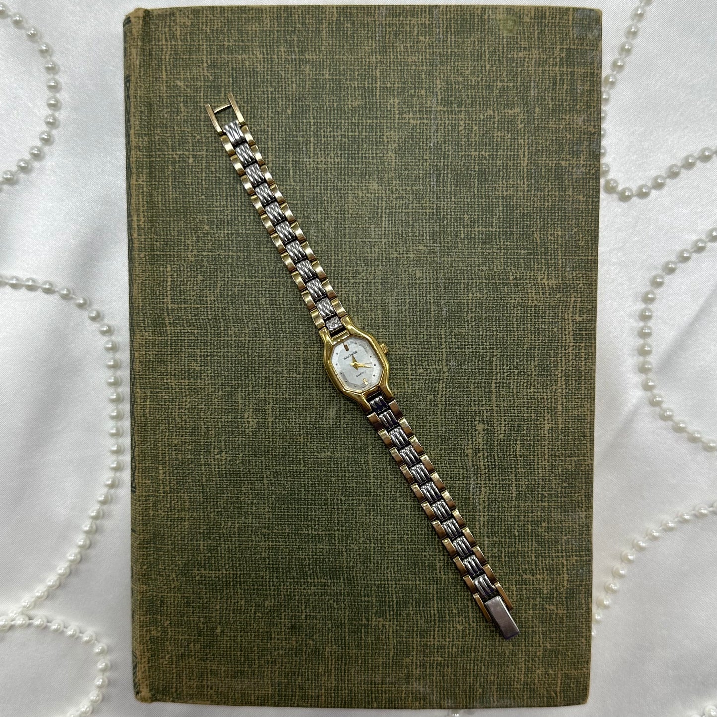 Vintage silver and gold tone Waltham watch with quartz movement.