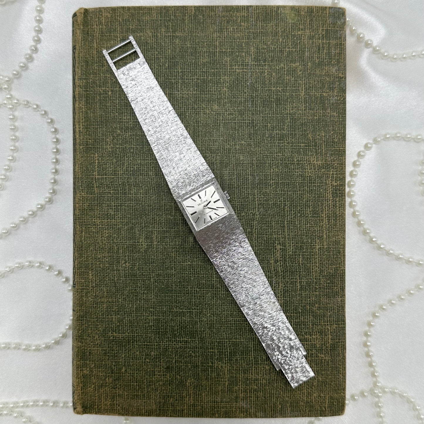 Vintage silver tone 17 jewels Swiss made, manual winding Excalibur tank watch with square dial and textured clasp band.