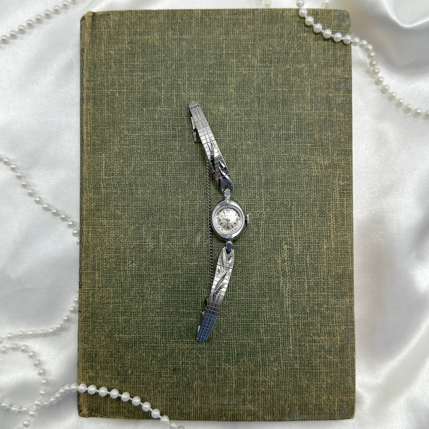 Vintage silver tone Benrus manual winding watch with detailed clasp band. Watch comes with original B crown. 
