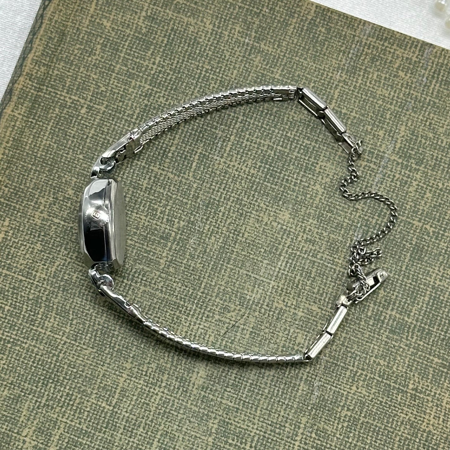 Vintage silver tone Benrus manual winding watch with detailed clasp band. Watch comes with original B crown