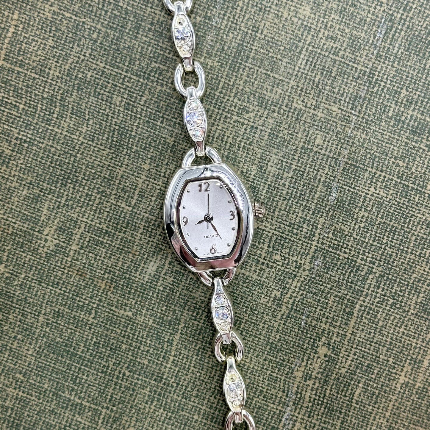 Vintage silver tone watch with elegant diamanté bracelet band and quartz movement.