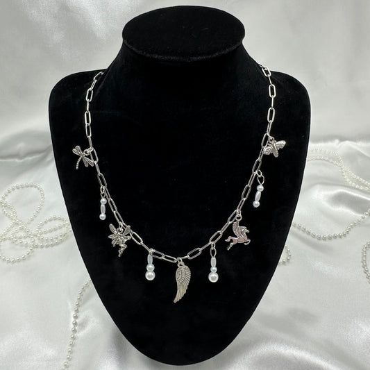 Vintage style silver tone paperclip chain necklace with wing charms and faux colored pearls.