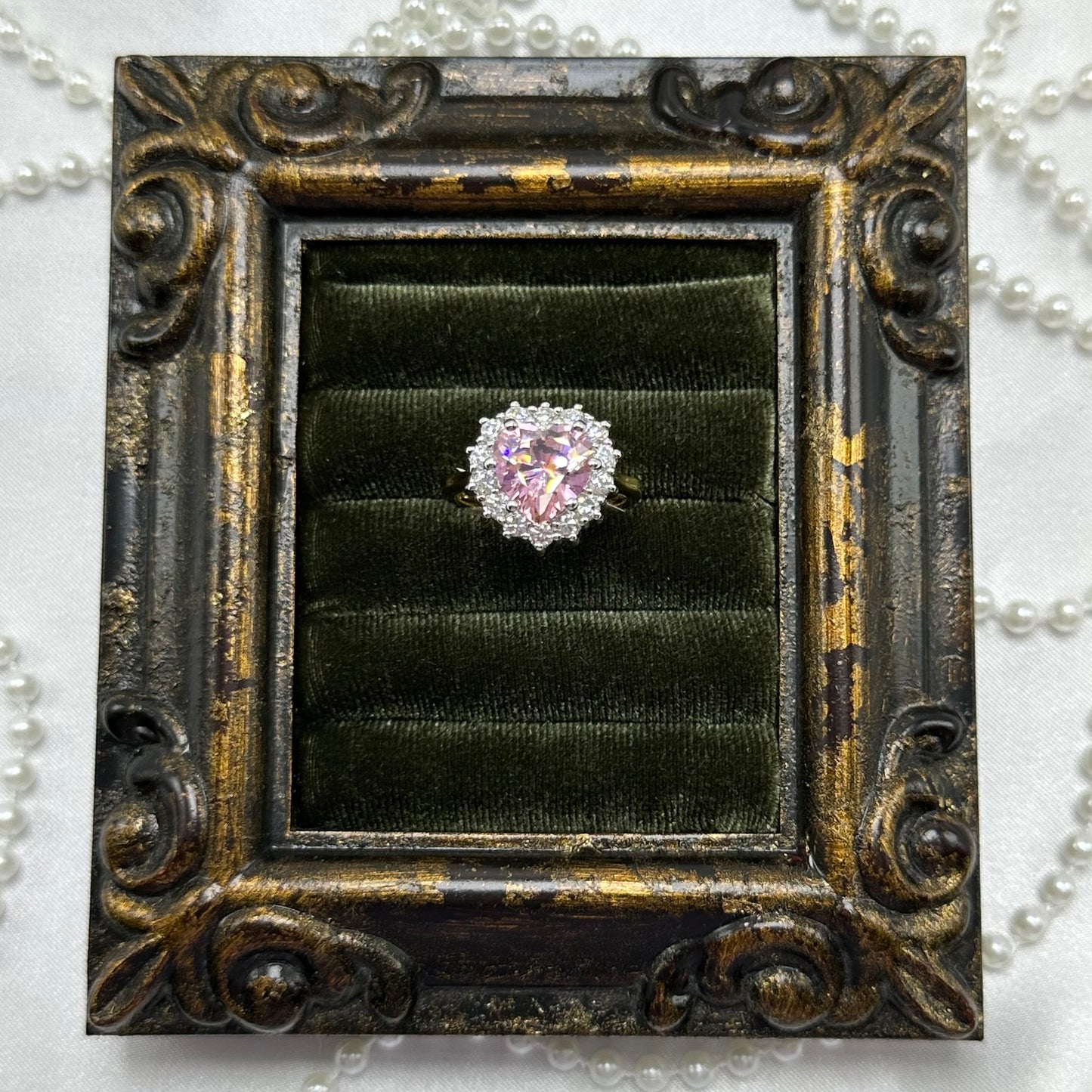 14k gold electroplated vintage deadstock ring with large pink heart shaped center stone surrounded by cubic zirconia stones.