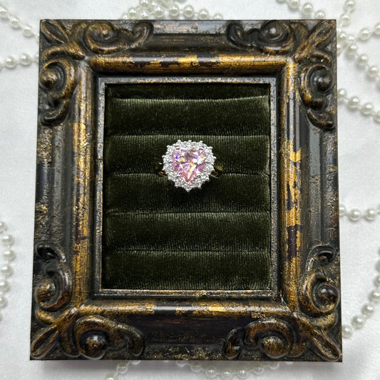 14k gold electroplated vintage deadstock ring with large pink heart shaped center stone surrounded by cubic zirconia stones.