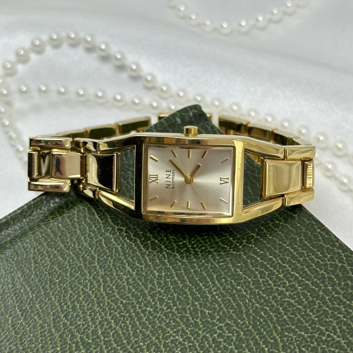 Classic Gold Nine & Company Watch with Rectangular Dial