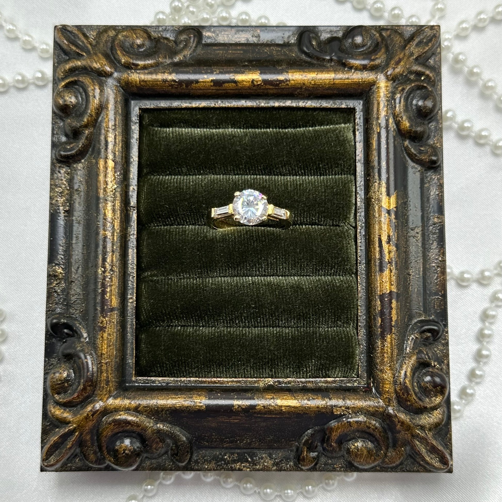 14k gold electroplated vintage deadstock cocktail ring with CZ round stone surrounded by two rectangular cubic zirconia stones.