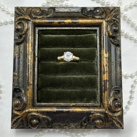 14k gold electroplated vintage deadstock cocktail ring with CZ round stone surrounded by two rectangular cubic zirconia stones.