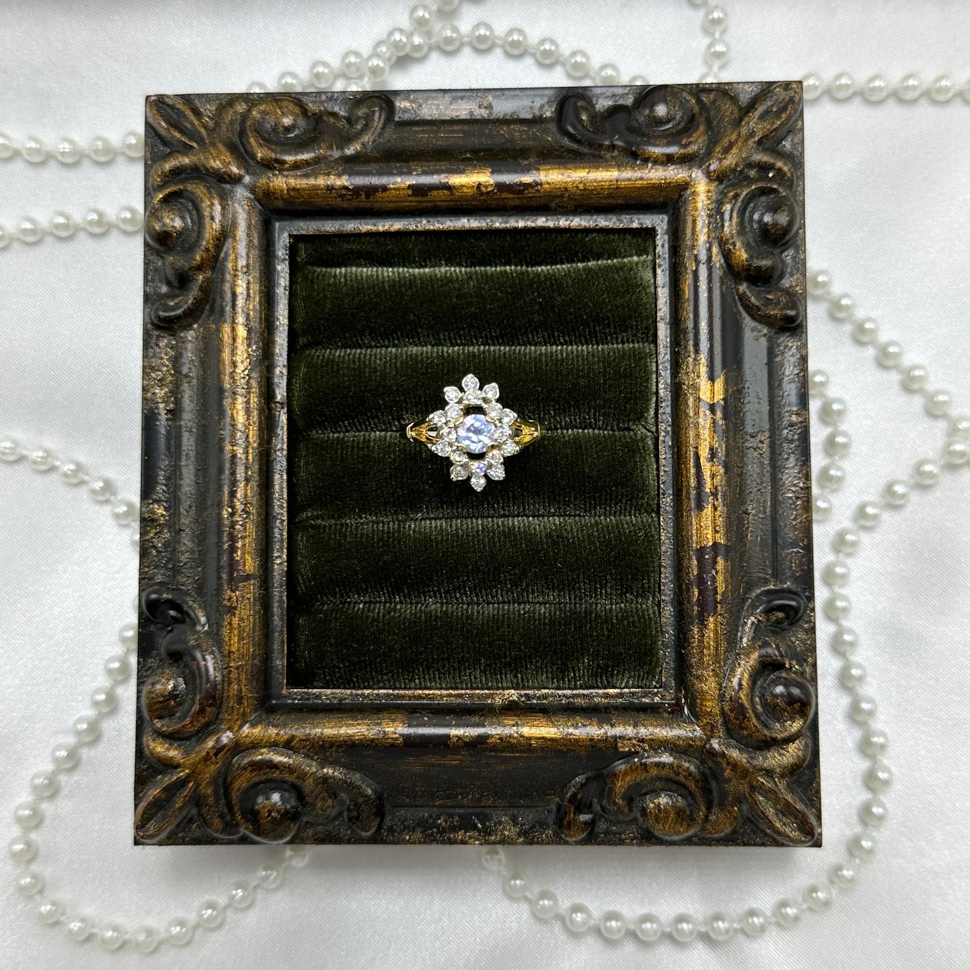 14k gold electroplated vintage deadstock cocktail ring with light purple center stone surrounded by cubic zirconia stones.