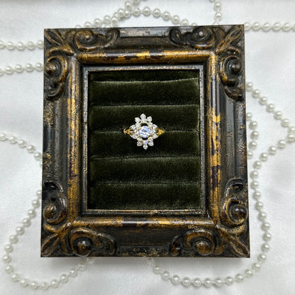 14k gold electroplated vintage deadstock cocktail ring with light purple center stone surrounded by cubic zirconia stones.