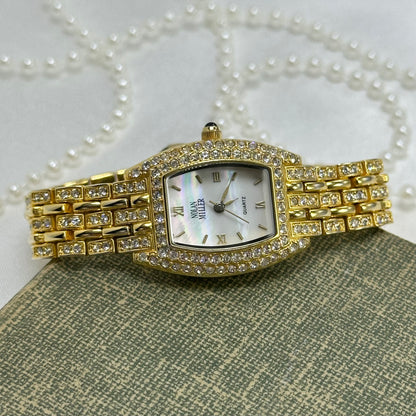 Elegant Crystal Gold Nolan Miller Watch with Mother of Pearl Dial