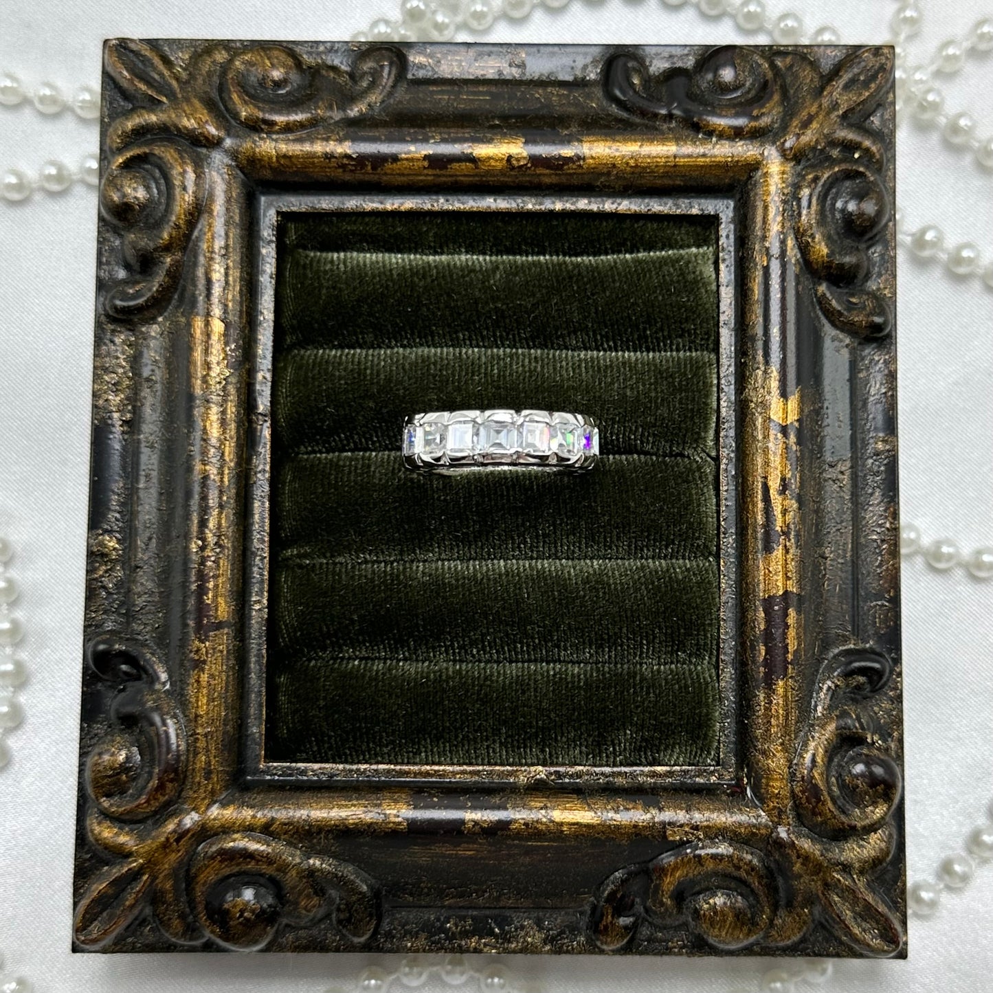 Rhodium plated vintage deadstock infinity band ring with clear rectangular cubic zirconia stones.