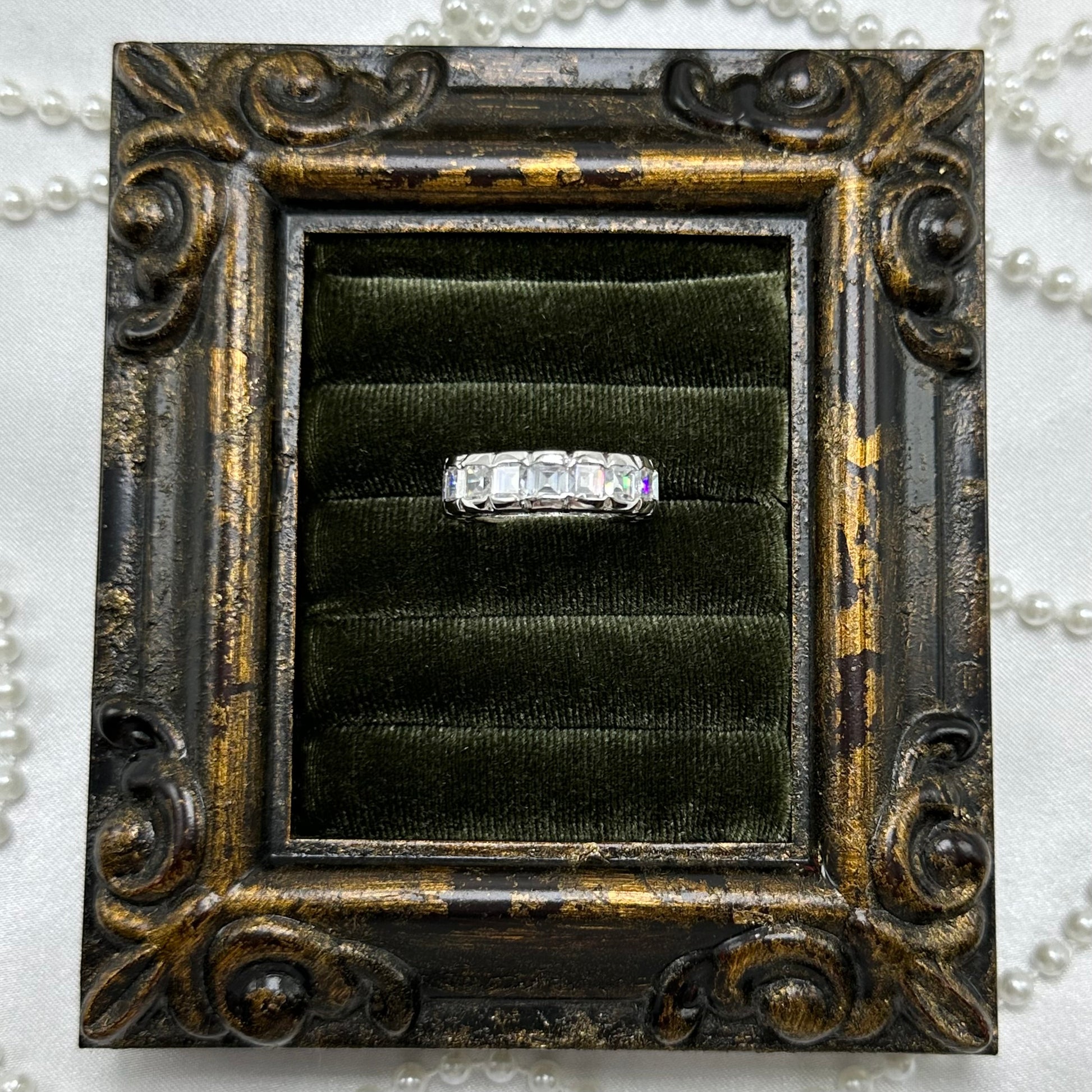 Rhodium plated vintage deadstock infinity band ring with clear rectangular cubic zirconia stones.