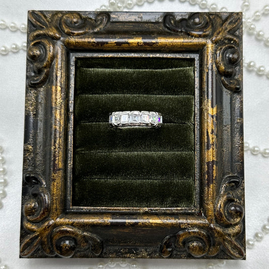 Rhodium plated vintage deadstock infinity band ring with clear rectangular cubic zirconia stones.