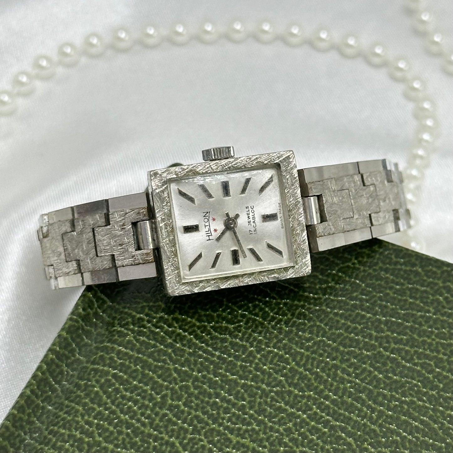 Vintage silver tone manual winding Hilton 17 jewels watch with clasp band. Chrome plated diamond cut link bracelet band.