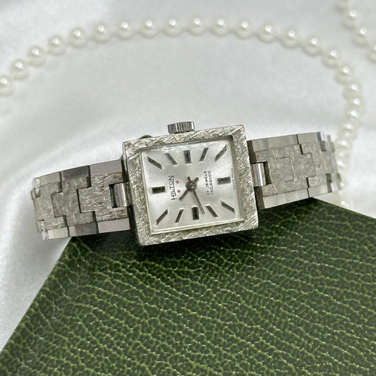 Vintage silver tone manual winding Hilton 17 jewels watch with clasp band. Chrome plated diamond cut link bracelet band.