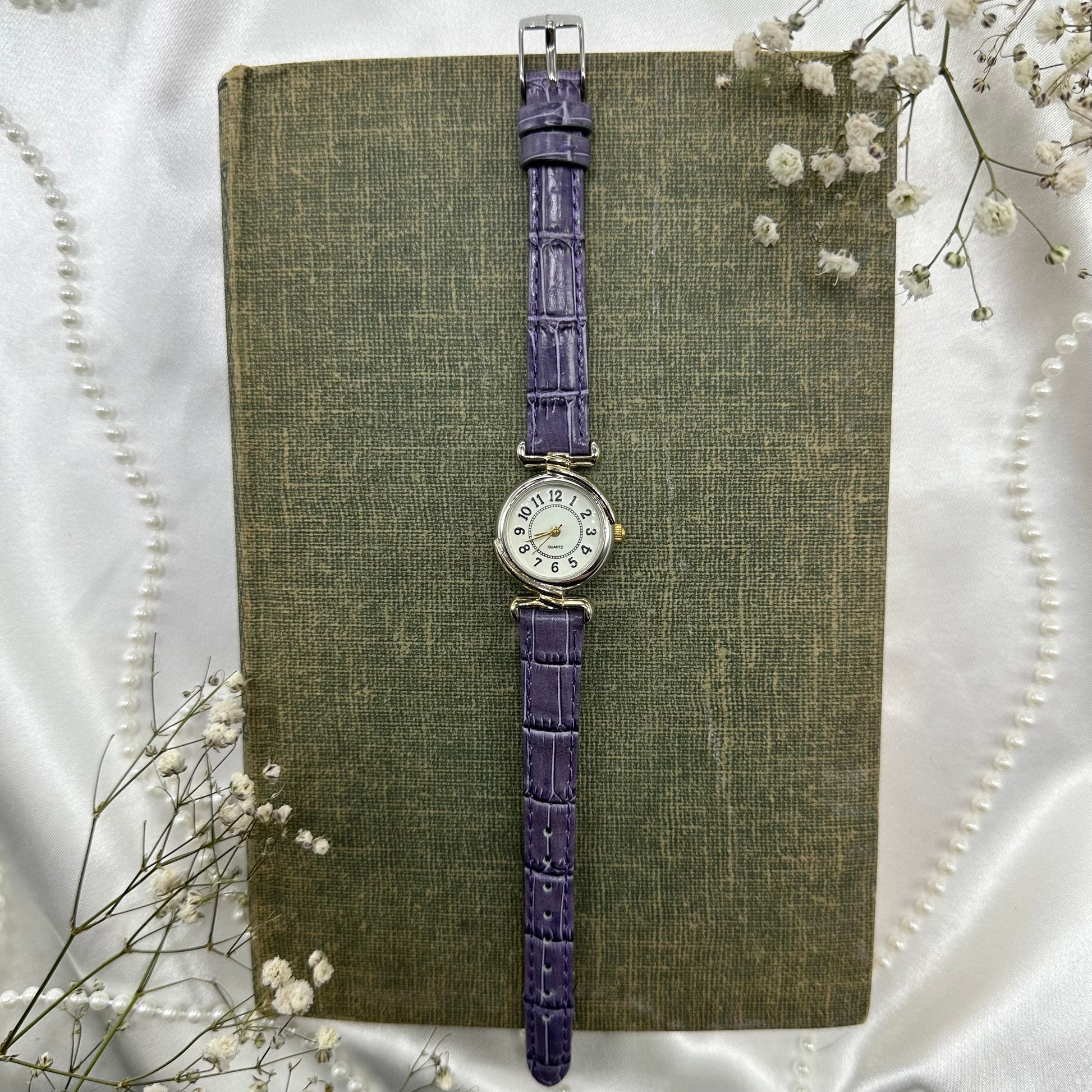 Vintage silver and gold tone watch with purple band and quartz movement