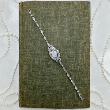 Elegant Crystal Silver Nolan Miller Watch with Mother of Pearl Dial